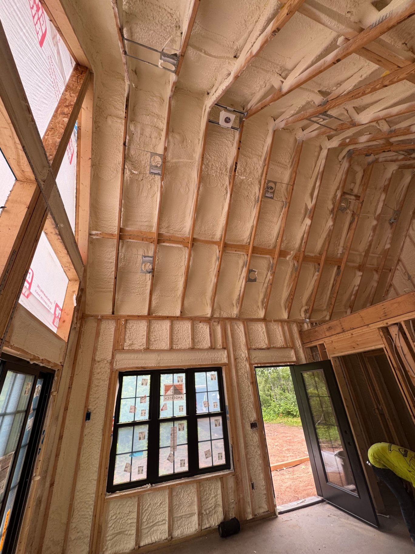 Spray foam insulation on vaulted cathedral ceiling walls and rafters in a Central Minnesota home