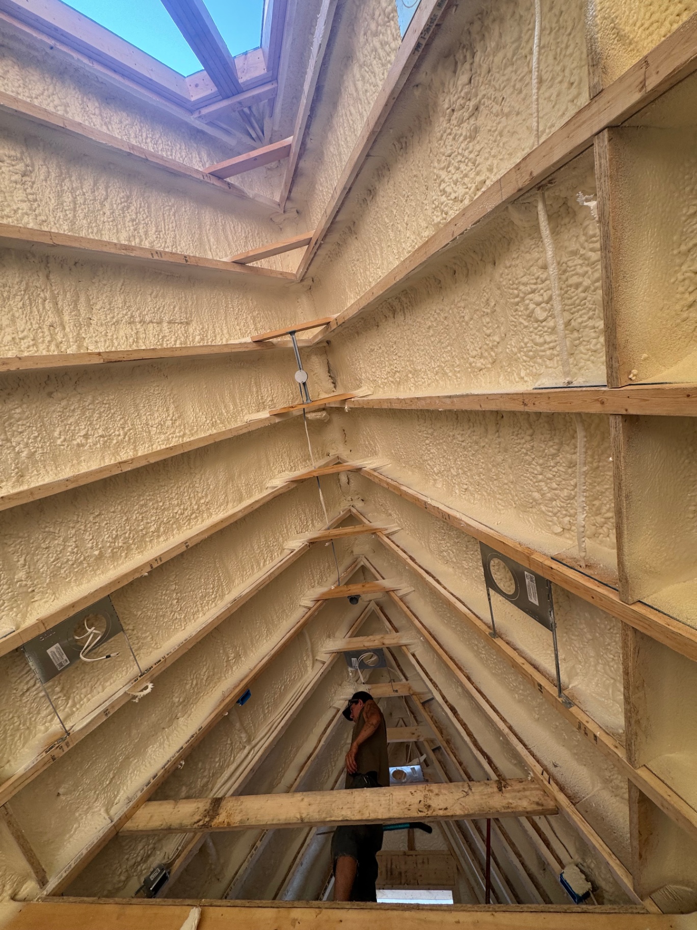 Open-cell spray foam insulation applied to attic rafters and vaulted ceiling with skylight in a Princeton MN home