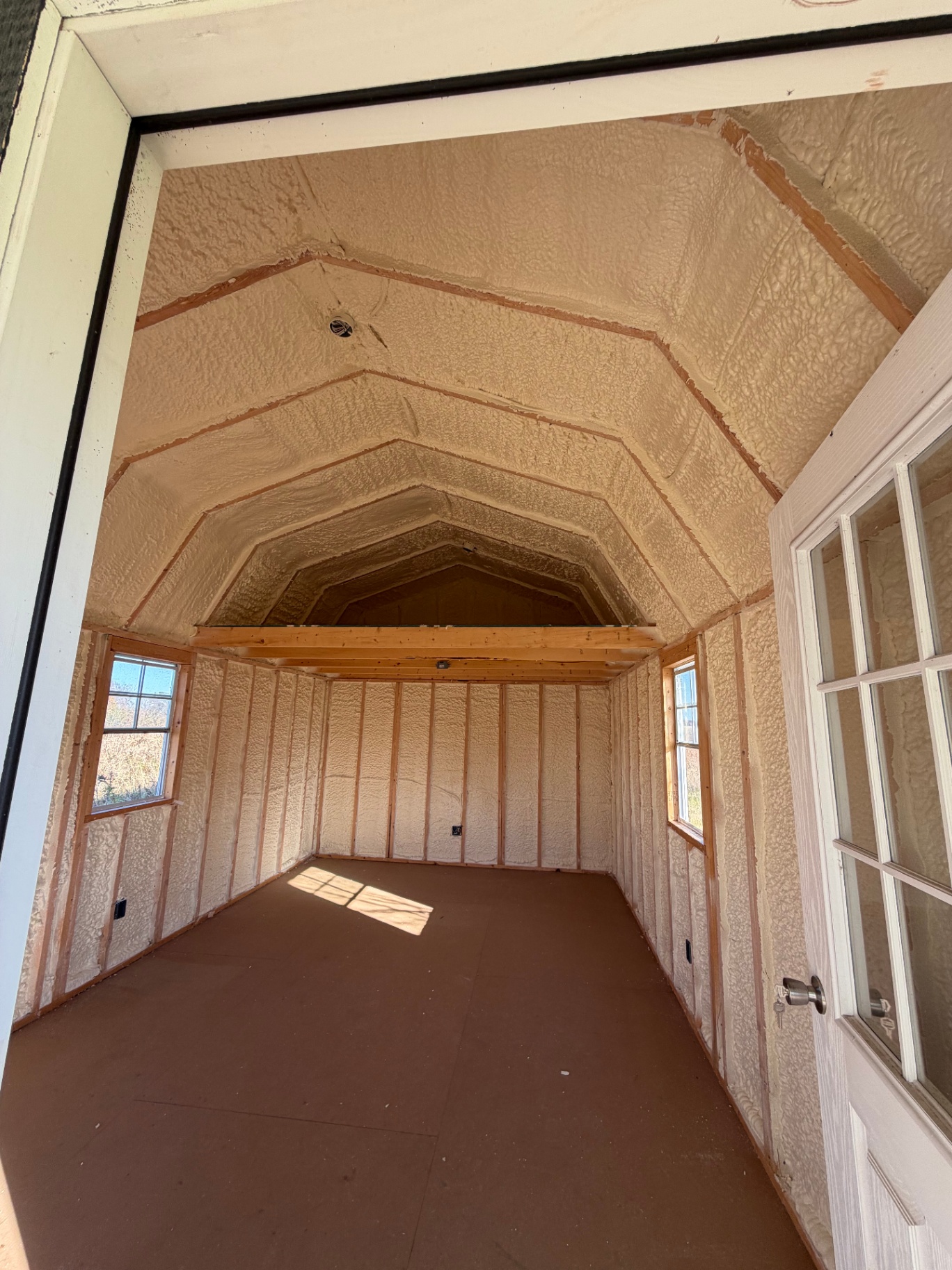 Spray foam insulation in a finished storage shed with gambrel roof