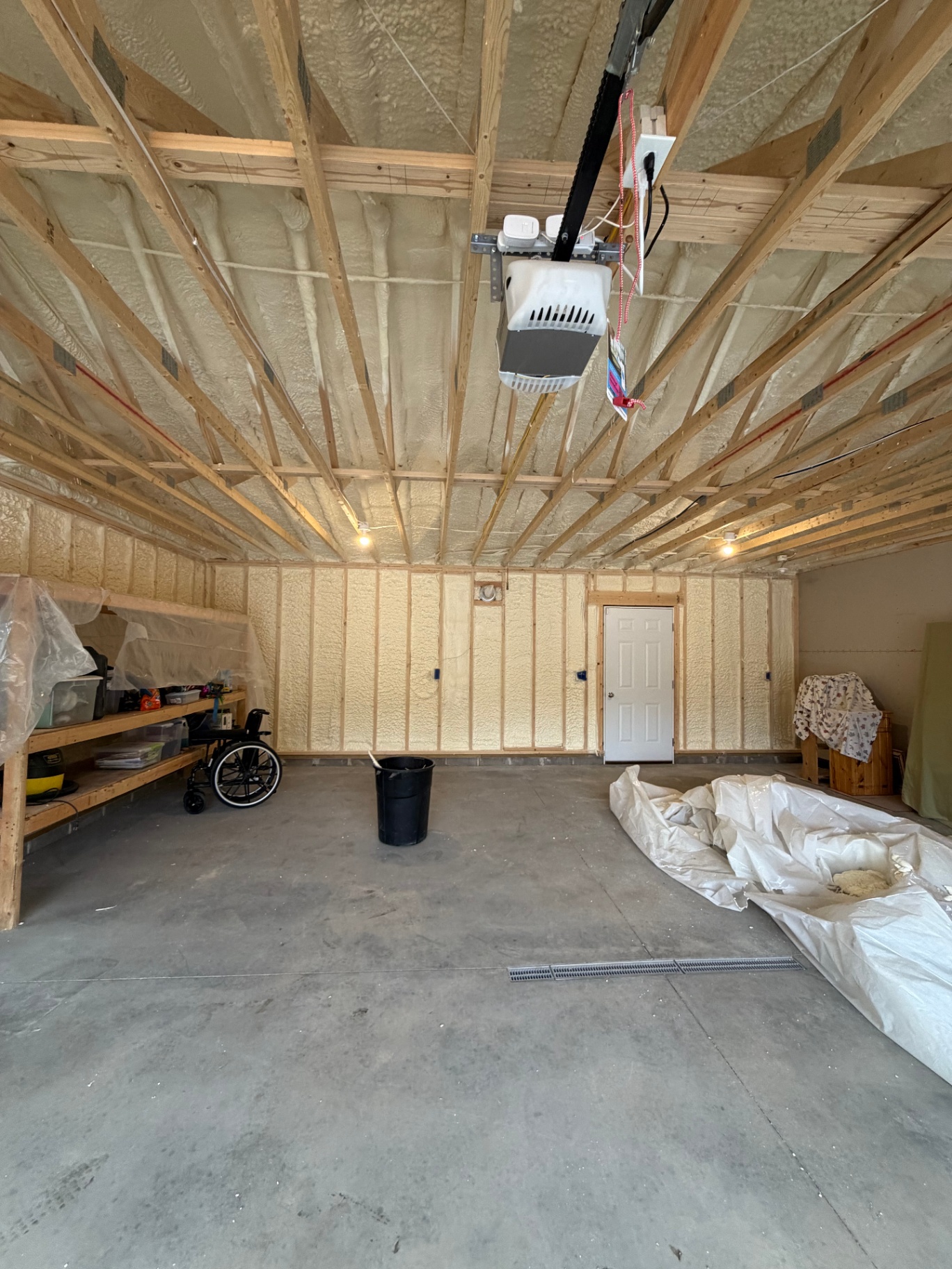 Spray foam insulation in finished garage walls and ceiling rafters